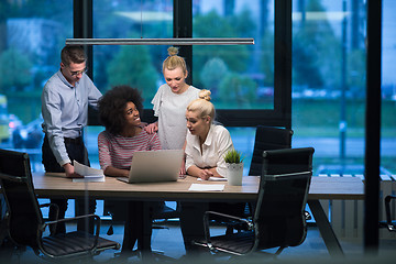 Image showing Multiethnic startup business team in night office