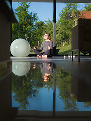 Image showing young woman doing morning yoga exercises