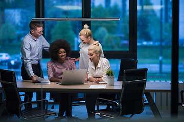 Image showing Multiethnic startup business team in night office