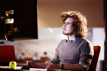 Image showing Tired businessman working late