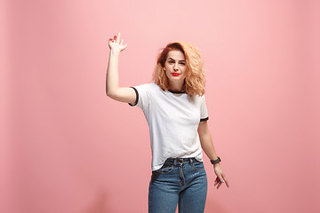 Image showing Beautiful female half-length portrait isolated on pink studio backgroud. The young emotional surprised woman