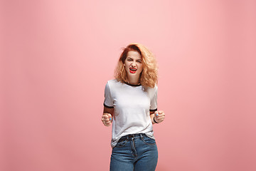 Image showing Portrait of an angry woman looking at camera isolated on a pink background