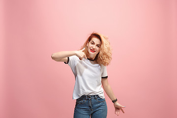 Image showing Beautiful female half-length portrait isolated on pink studio backgroud. The young emotional surprised woman