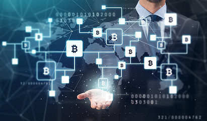 Image showing close up of businessman with bitcoin block chain