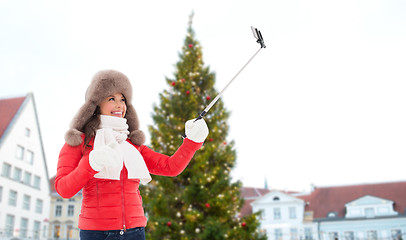 Image showing woman taking selfie over christmas tree