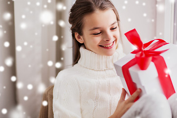 Image showing happy beautiful girl with christmas gift at home