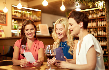 Image showing women looking at bill at wine bar or restaurant