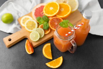 Image showing mason jar glass with juice and fruits on table