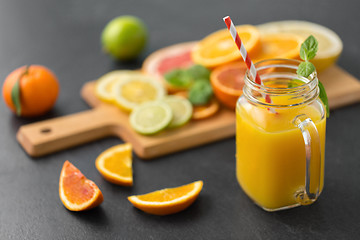 Image showing mason jar glass of fruit juice on slate table top