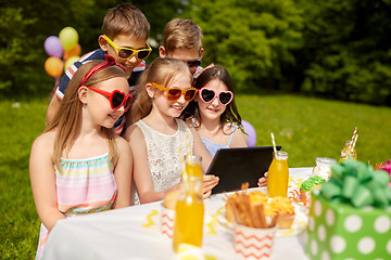 Image showing happy kids with tablet pc on birthday party