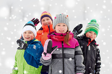 Image showing happy little kids in winter clothes outdoors