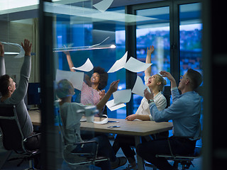 Image showing multiethnic Group of young business people throwing documents