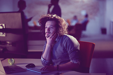 Image showing man working on computer in dark office