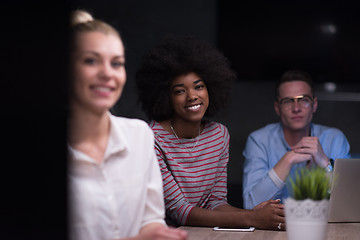 Image showing Multiethnic startup business team in night office