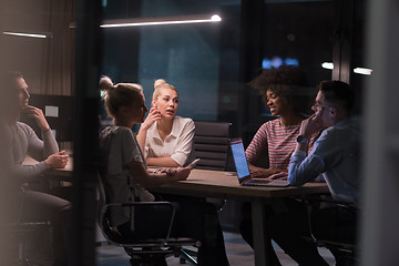 Image showing Multiethnic startup business team in night office