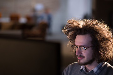 Image showing man working on computer in dark office