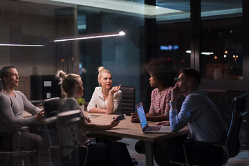 Image showing Multiethnic startup business team in night office