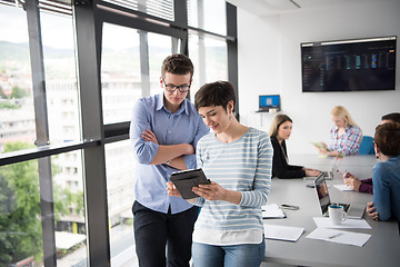 Image showing Two Business People Working With Tablet in office