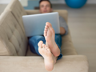 Image showing Man using laptop in living room