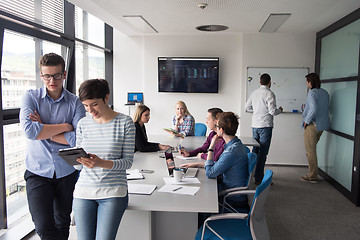 Image showing Two Business People Working With Tablet in office