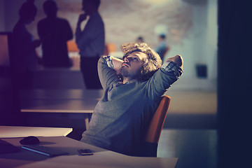 Image showing businessman relaxing at the desk