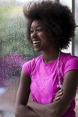 Image showing portrait of young afro american woman in gym while listening mus