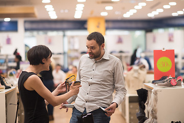 Image showing couple chooses shoes At Shoe Store