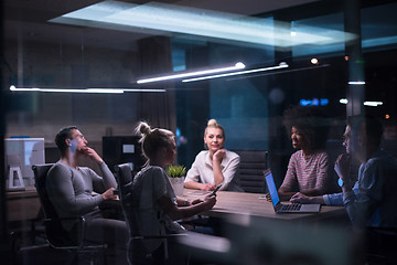 Image showing Multiethnic startup business team in night office