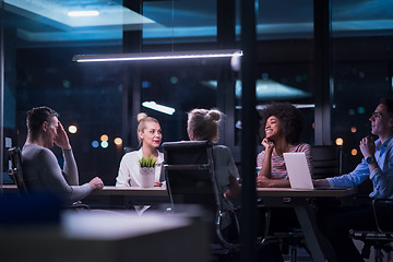 Image showing Multiethnic startup business team in night office