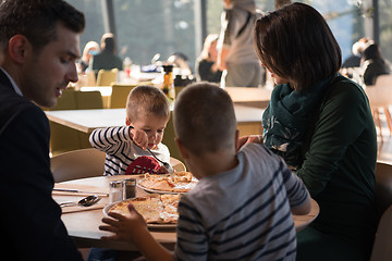 Image showing Young parents enjoying lunch time with their children