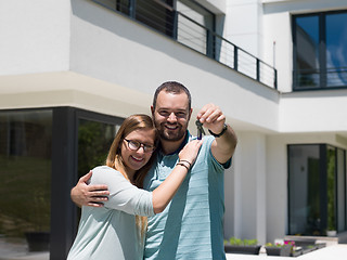 Image showing couple hugging in front of  new luxury home