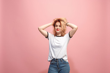 Image showing The happy business woman standing and smiling against pink background.