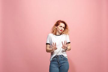 Image showing Let me think. Doubtful pensive woman with thoughtful expression making choice against pink background