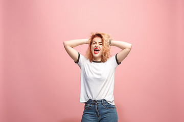 Image showing Isolated on pink young casual woman shouting at studio