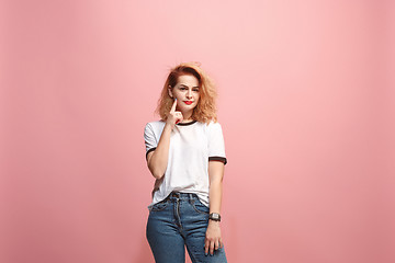 Image showing Let me think. Doubtful pensive woman with thoughtful expression making choice against pink background