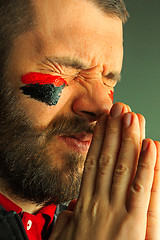 Image showing Portrait of a man with the flag of the Germany painted on him face.