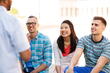 Image showing happy international friends talking in city