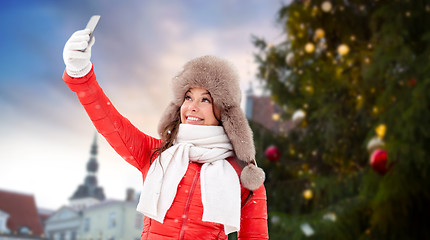 Image showing woman taking selfie over christmas tree