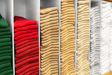 Image showing close up of shelves with clothes at clothing store