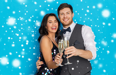 Image showing happy couple with champagne celebrating christmas