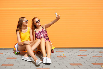 Image showing teenage girls with skateboards taking selfie