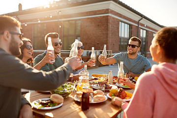 Image showing happy friends toasting drinks at rooftop party