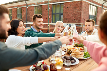 Image showing happy friends toasting drinks at rooftop party