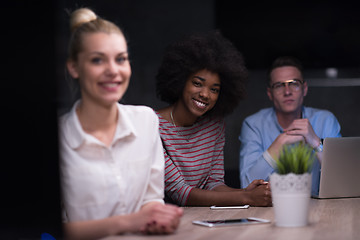 Image showing Multiethnic startup business team in night office