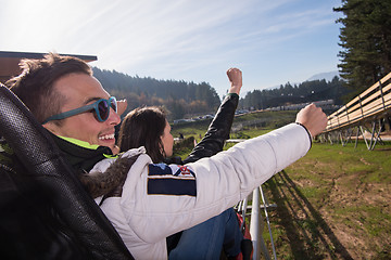 Image showing couple enjoys driving on alpine coaster