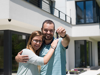 Image showing couple hugging in front of  new luxury home