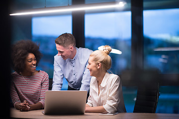 Image showing Multiethnic startup business team in night office