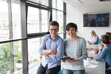 Image showing Two Business People Working With Tablet in office