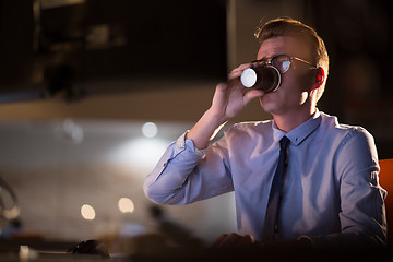 Image showing Tired businessman working late