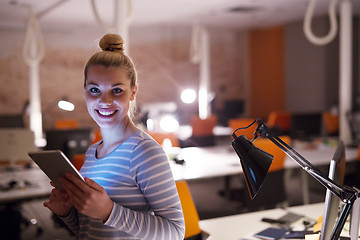 Image showing woman working on digital tablet in night office